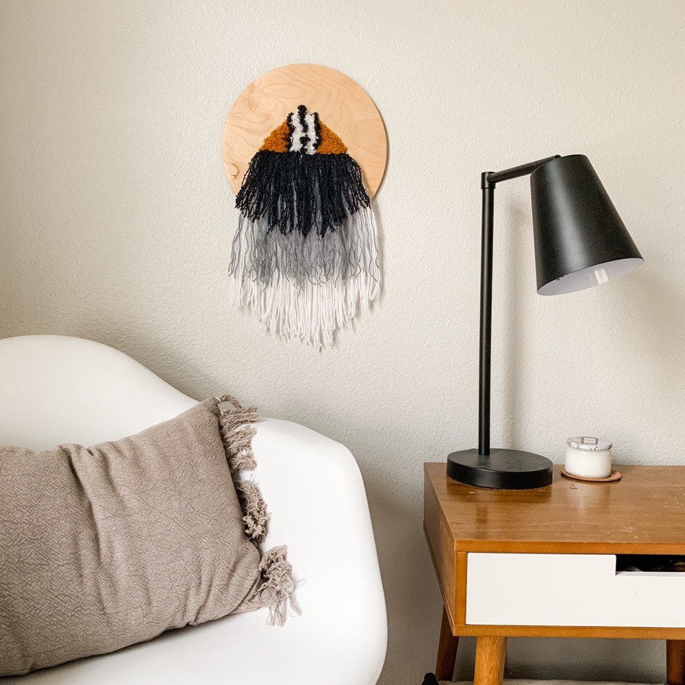 Tapestry attached to wood round